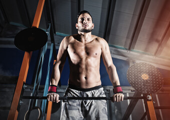 Fototapeta na wymiar Determined athletic man works out at the gym with the bar