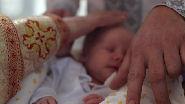 Baptism of a child in the church. Baptism of a child. Traditions in the Ukrainian Church. Anointing and prayer to God. Little Christian. Greek Catholic Church