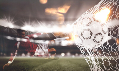 Double exposure image with a ball pierces the soccer goal at the stadium during a night match and a...