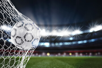 Soccer ball pierces the soccer goal at the stadium during a night match. 3D Rendering
