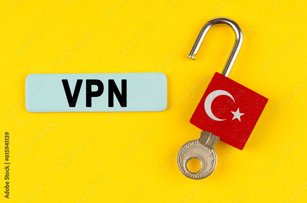 Poster on the yellow surface is an open lock with a key and a sticker with the inscription - vpn