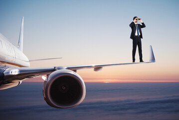 Businessman with binoculars over a fast aircraft searches for new business opportunities