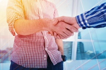 Handshaking business person in the office. concept of teamwork and business partnership. double exposure