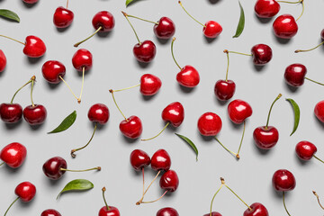 Fototapeta na wymiar Many sweet cherries on grey background