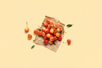 Paper with sweet cherries on light background