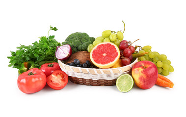Wicker bowl with different fresh fruits and vegetables on white background