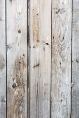 Old wooden vertical planks texture with scratches and cracks. Wooden background for design