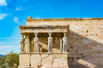 The Porch of the Caryatids at the Erechtheion temple on the Acropolis, Athens, Greece. Six columns sculpted as figures of maidens in place of ordinary columns. - obrazy, fototapety, plakaty