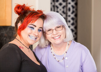 Mother and daughter in kitchen smiling