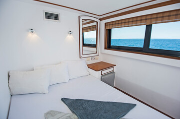 Double bed in cabin of a luxury private motor yacht