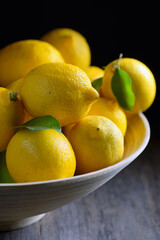 lemons with leaves on an old wooden table