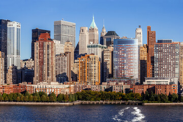 Photo of midtown Manhattan cityscape in New York city, taken from a ferry on the Hudson.