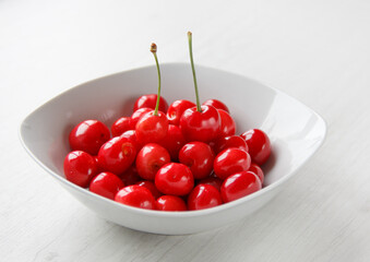 Obraz na płótnie Canvas plate with ripe, juicy and sweet early red cherries.selective focus . High quality photo