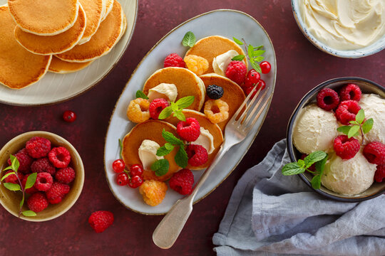 Pancake folded stack of fresh raspberries and mint. Food background, top view