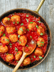 close up of rustic italian meatball in tomato sauce