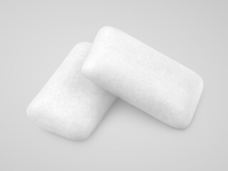 Two pieces of chewing gums on gray background with clipping path