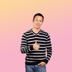 Asian man in striped pullovert, showing well done, isolated on trendy gradient background