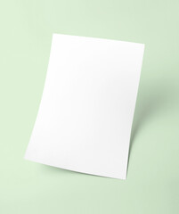 Obraz na płótnie Canvas The white blank document paper template with green background