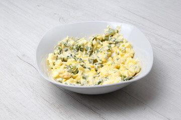 ready salad of cooked chicken eggs green onions and mayonnaise. selective focus