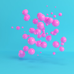 Pink flying spheres on bright blue background in pastel colors. Minimalism concept. 3d rendering