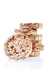 Round wheat crispbread, white background. Composition of grain crispbread on white background. Healthy and nutritious diet. Isolated on white