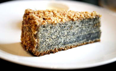 Photo of a macro delicious poppy cake slice in a restaurant