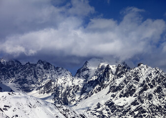 Fototapeta premium High snowy mountains in clouds at sunny day. Caucasus Mountains. Georgia, region Svaneti.