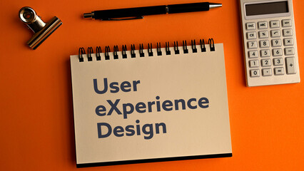 There is notebook with the word User eXperience Design. It is as an eye-catching image.