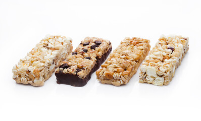 Protein cereal energy bars with nuts and caramel and chocolate for breakfast on white background