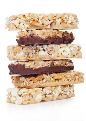 Protein cereal energy bars with nuts and caramel and chocolate for breakfast on white background
