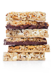 Protein cereal energy bars with nuts and caramel and chocolate for breakfast on white background