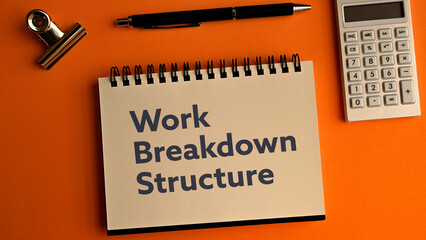 There is notebook with the word Work Breakdown Structure. It is as an eye-catching image.