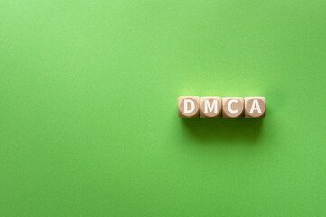 There is wood cube with the word DMCA. It is an abbreviation for Digital Millenium Copyright Act as eye-catching image.