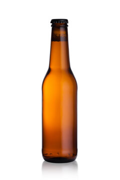 Brown glass lager beer bottle with black cap isolated on white background with reflection