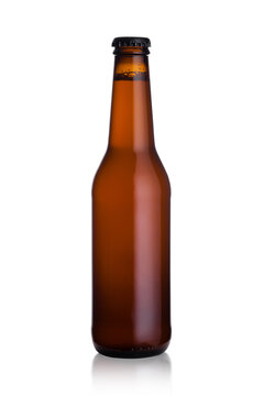 Brown glass lager beer bottle with black cap isolated on white background with reflection