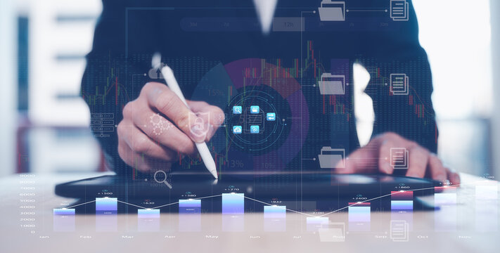 financial investment concept, businessman using computer tablet with virtual trading graph stock or cryptocurrency exchange in concept of investment business growth and marketing