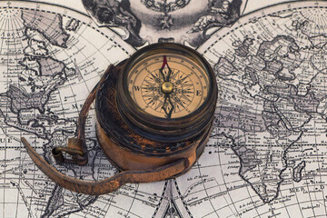 Fototapeta na wymiar Ancient compass on the world map.