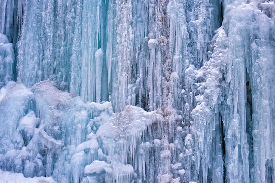 Closeup photo of a beautiful ice formation during a cold winter, formed on a mountain wall