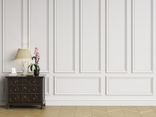 Classic sideboard with decor in classic interior with copy space.White walls with mouldings and...