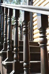 railing of a wooden staircase outside a wooden building