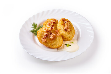 Potato dumplings - a traditional regional dish. Polish and Lithuanian cuisine. With fried bacon on a white plate.