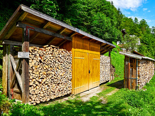 Hallstatt, Austria. Wood stack with stacked firewood stock for winter heating.