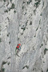 man rock climber climbs on the cliff. the climber climbs to the top of the mountain.