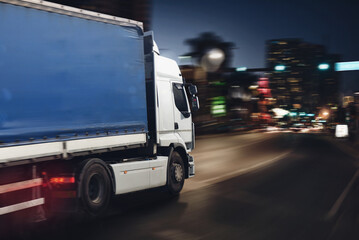 Moving truck on a city road with skyscrapers background