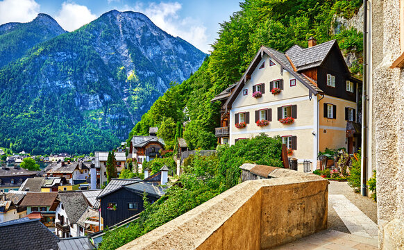 Hallstatt Austria vintage architecture and old houses in picturesque austrian mountains Alps on lake Hallstattersee. Paved stone walks among green trees.