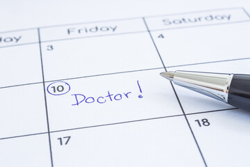 Closeup the blue word&Acirc;&nbsp;Doctor written on timetable with circle mark. Modern pen put on calendar sheet, blurred at edges. Health reminder note, hospital schedule, appointment date, time management.