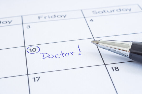 Closeup the blue wordÂ Doctor written on timetable with circle mark. Modern pen put on calendar sheet, blurred at edges. Health reminder note, hospital schedule, appointment date, time management.