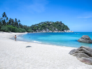 Tourists on the sand of remote haad tien beach on Koh Phangan island in the gulf of thailand