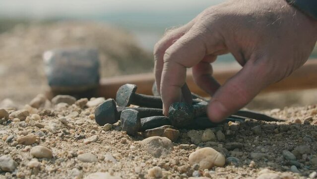 Hammer and nails placed on the ground for the crucifixion of Jesus. Focused detail