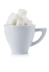 Cubes of white sugar in a white cup on a white background